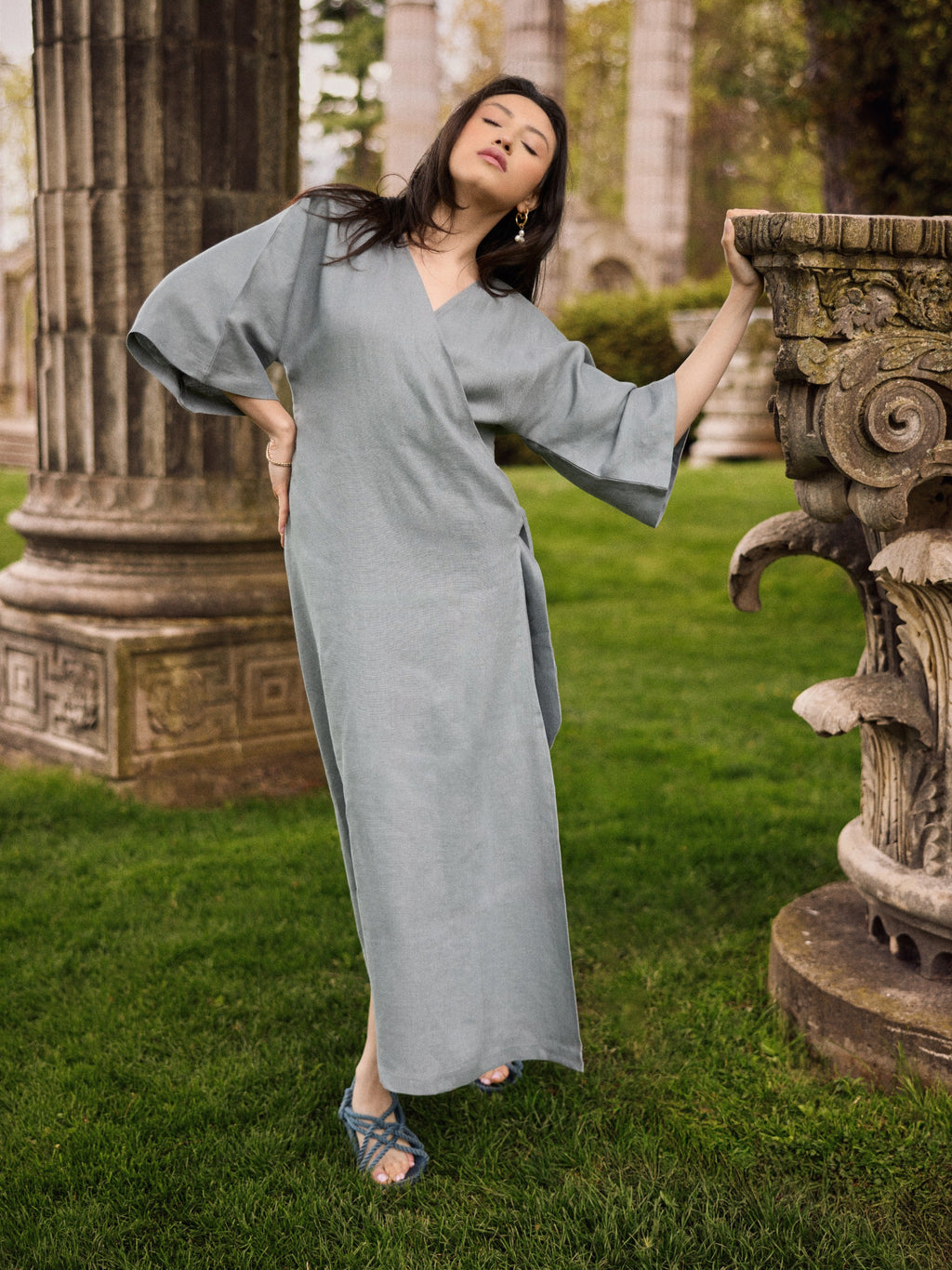 Model wearing a Vera linen robe dress in gray.